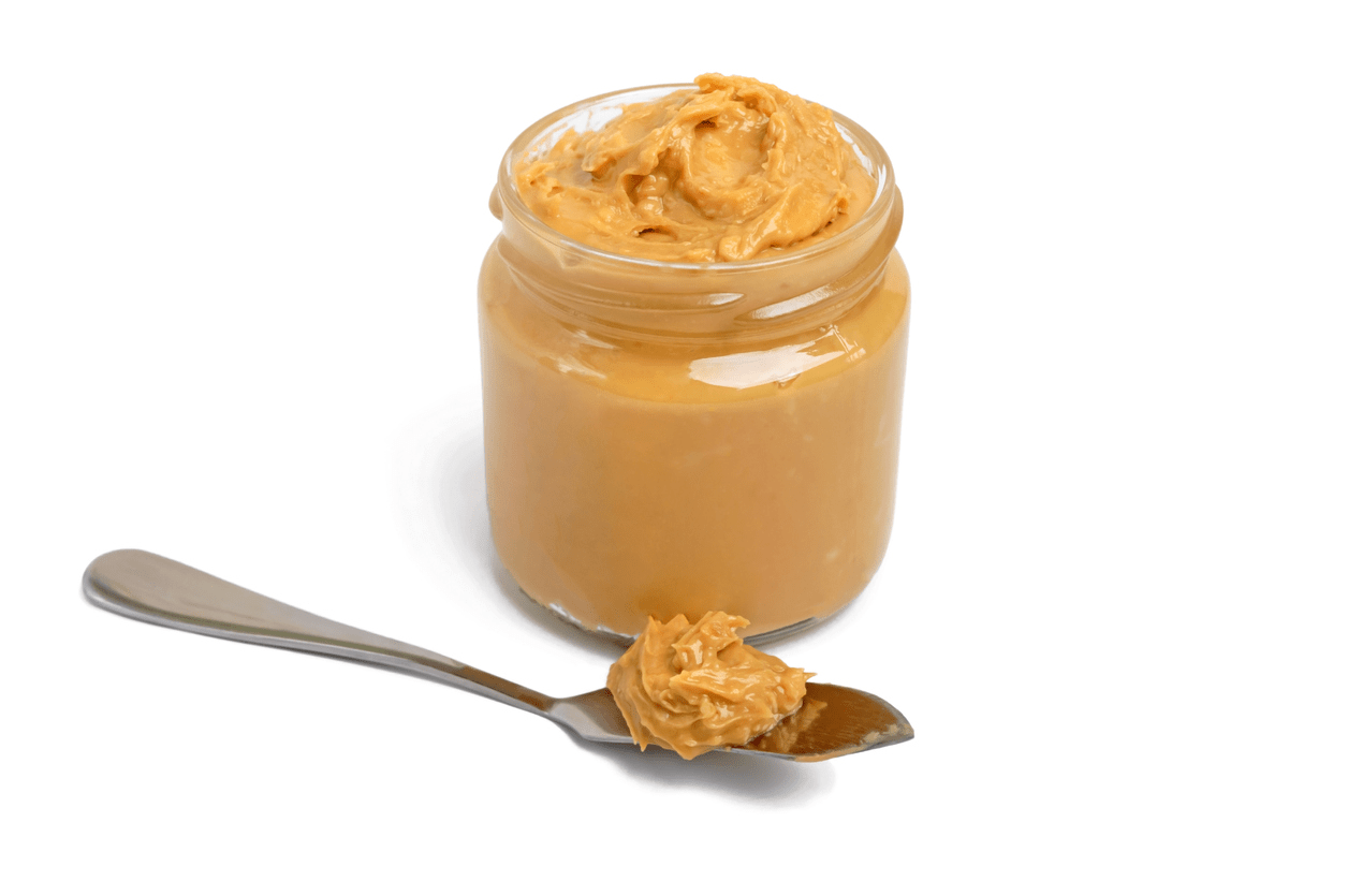 Photo of a jar of creamy peanut butter with a spoonful of peanut butter recall was happening in the USA due to salmonella