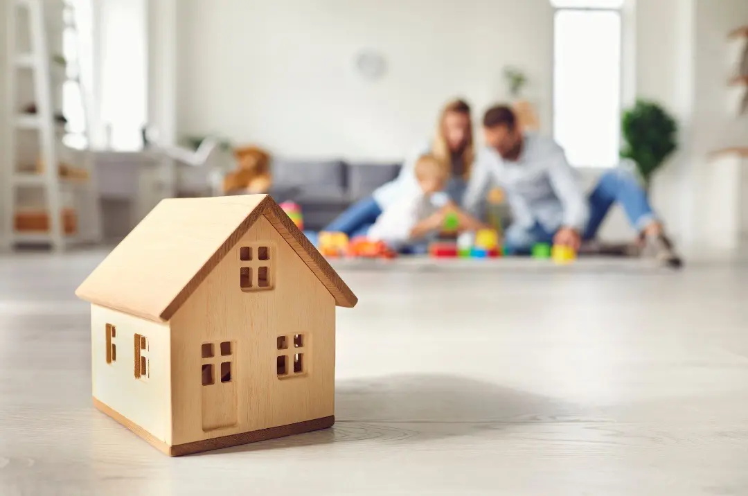 Young family joyfully playing with their child, demonstrating bonding and quality family time.